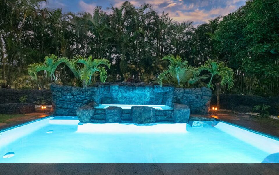 A pool with a bench and water features
