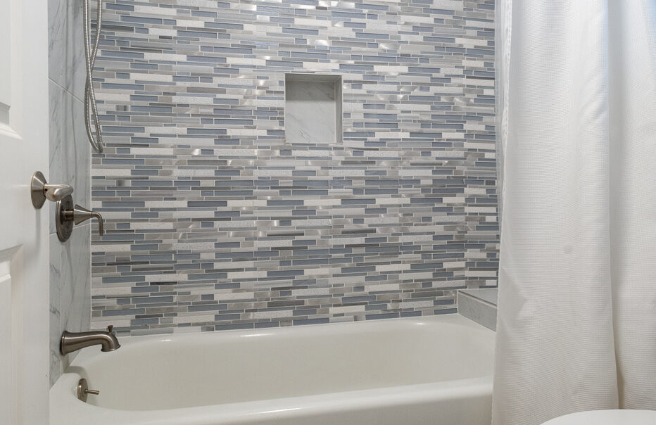 Modern bathroom with stylish mosaic tile wall.