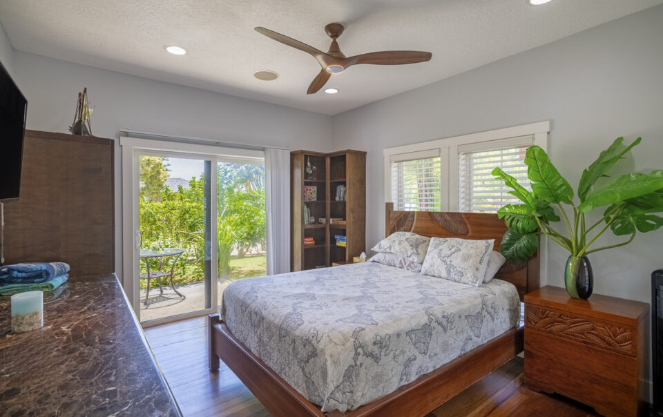Bright bedroom with garden view and decor.