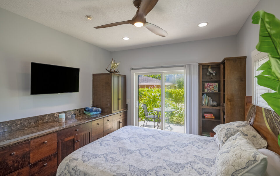 Bright bedroom with outdoor view and decor.