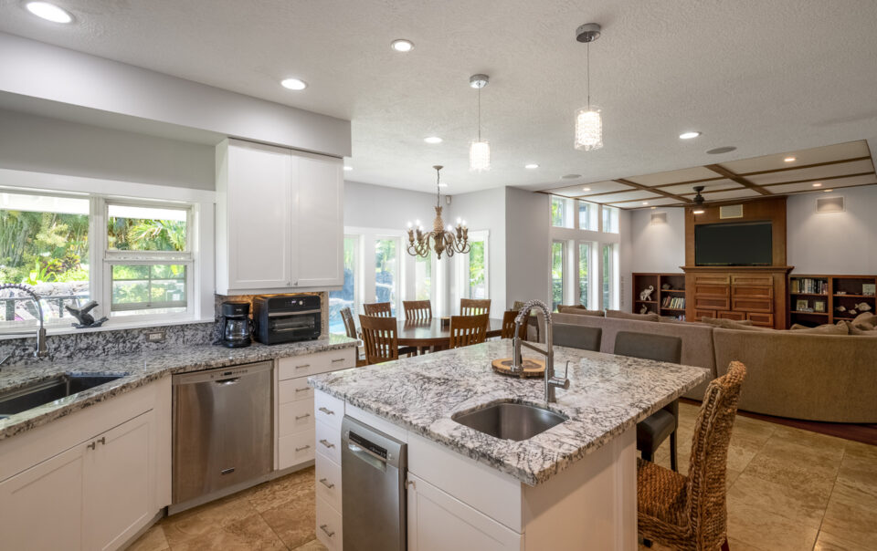 Spacious kitchen with modern appliances and seating.