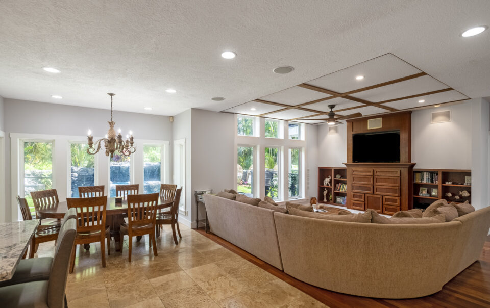 Spacious living room with large windows and seating.