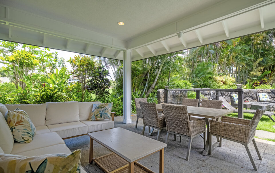 Lush outdoor seating area surrounded by greenery.