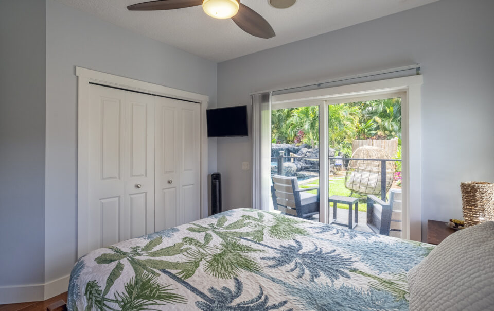 Serene bedroom with outdoor patio view.