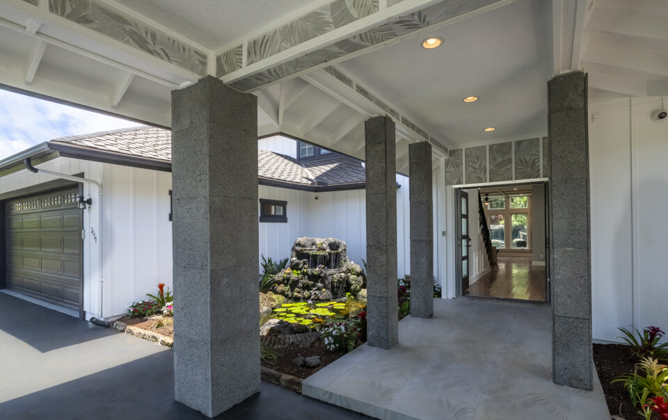 Welcoming entryway with water feature and greenery.