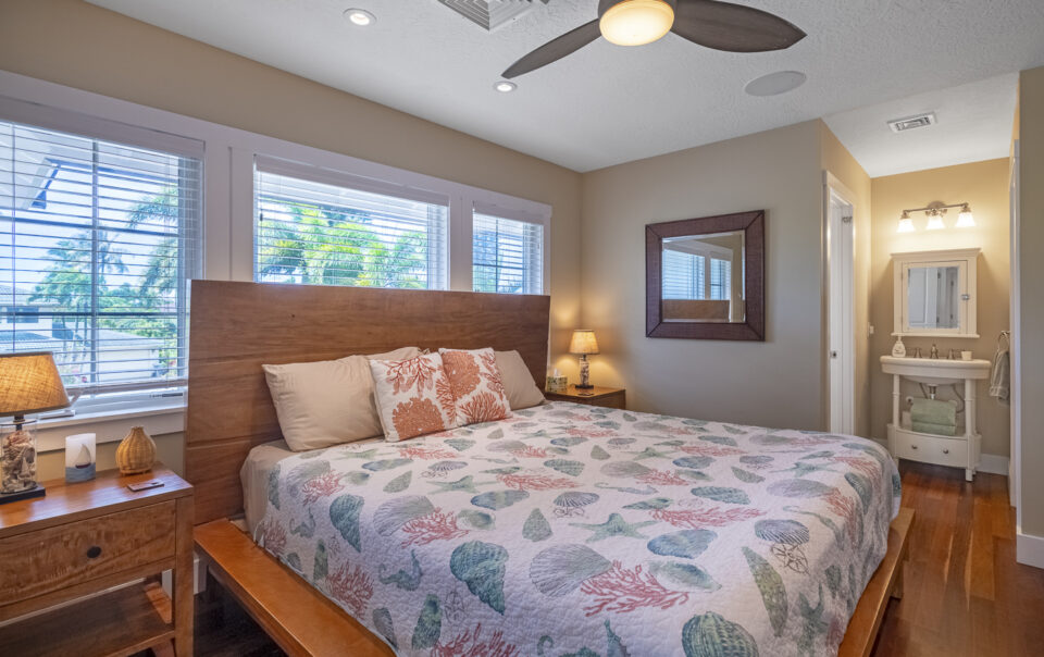 Cozy bedroom with sea-themed bedding and decor.