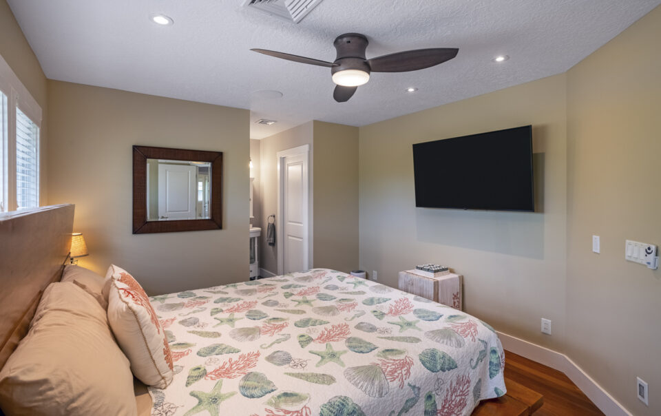 Cozy bedroom featuring a beach-themed quilt.
