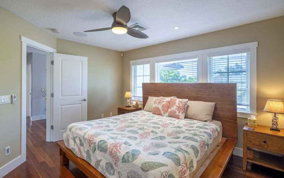 Bright bedroom with coastal-themed bedding and decor.