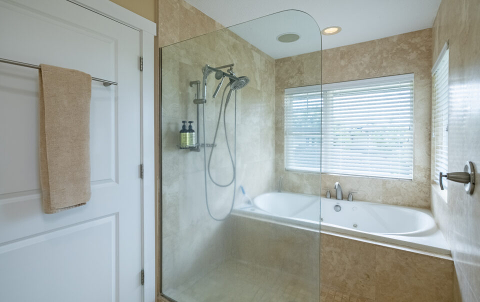 Modern bathroom with glass shower and tub.
