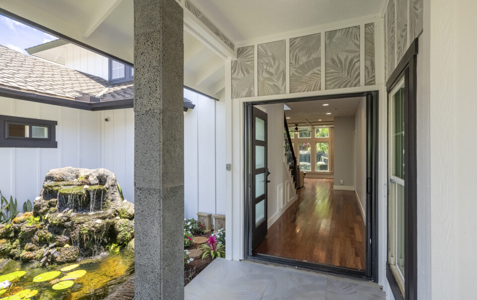 Welcoming entrance with water feature and plants.