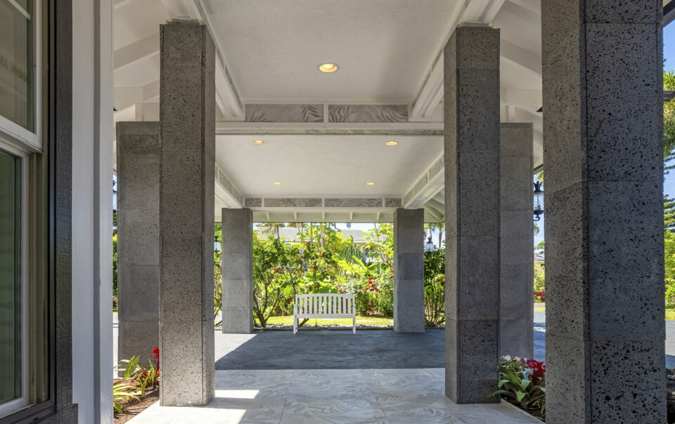 Spacious entryway with tropical landscaping and seating.