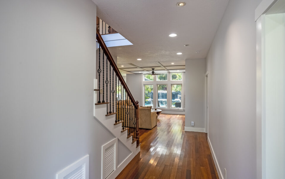 Bright hallway leading to a sunlit living area.